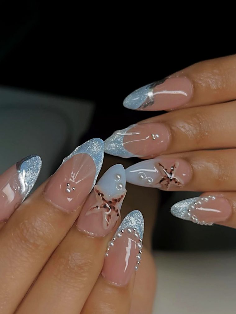 Almond nails with pale blue tips and 3D butterflies