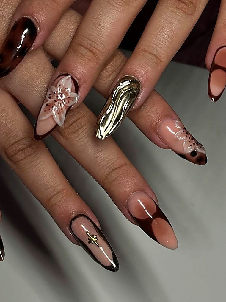 Tortoiseshell and chrome nails with a 3D lily and gold charm