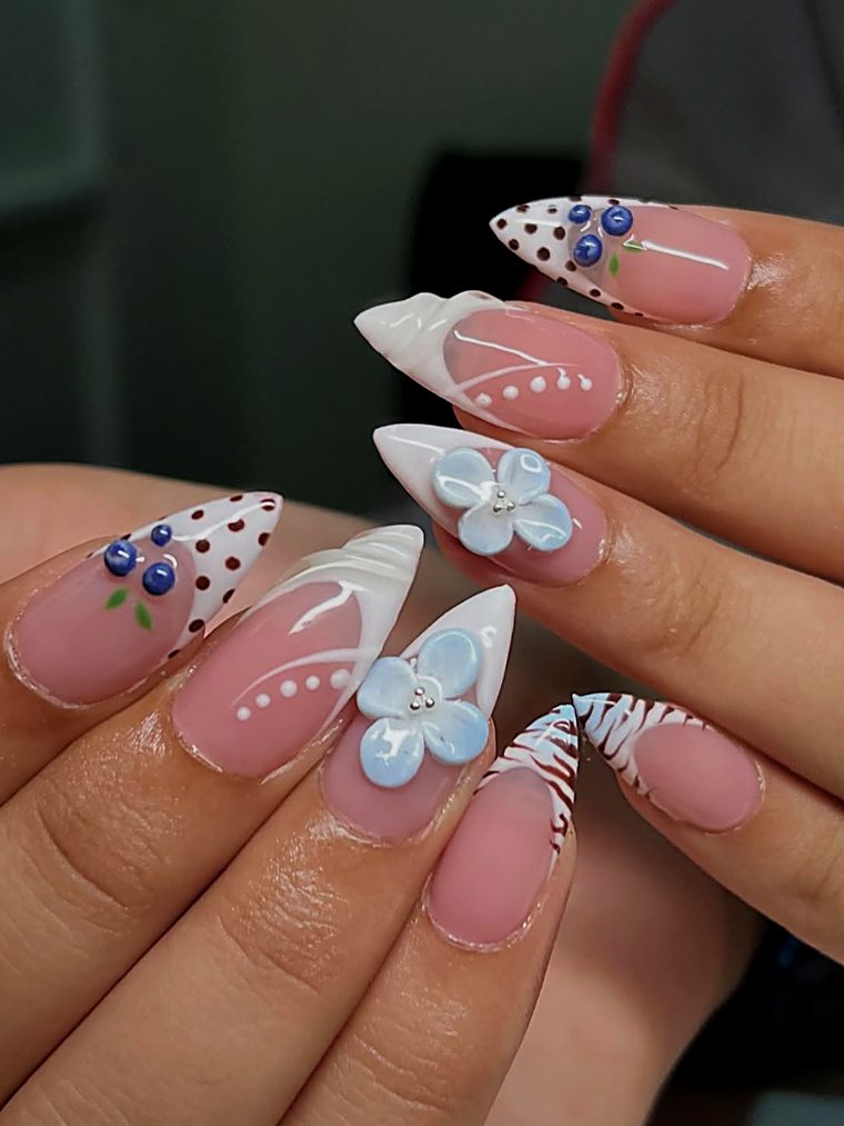 White nails with polka-dot tips, blueberries and a blue flower