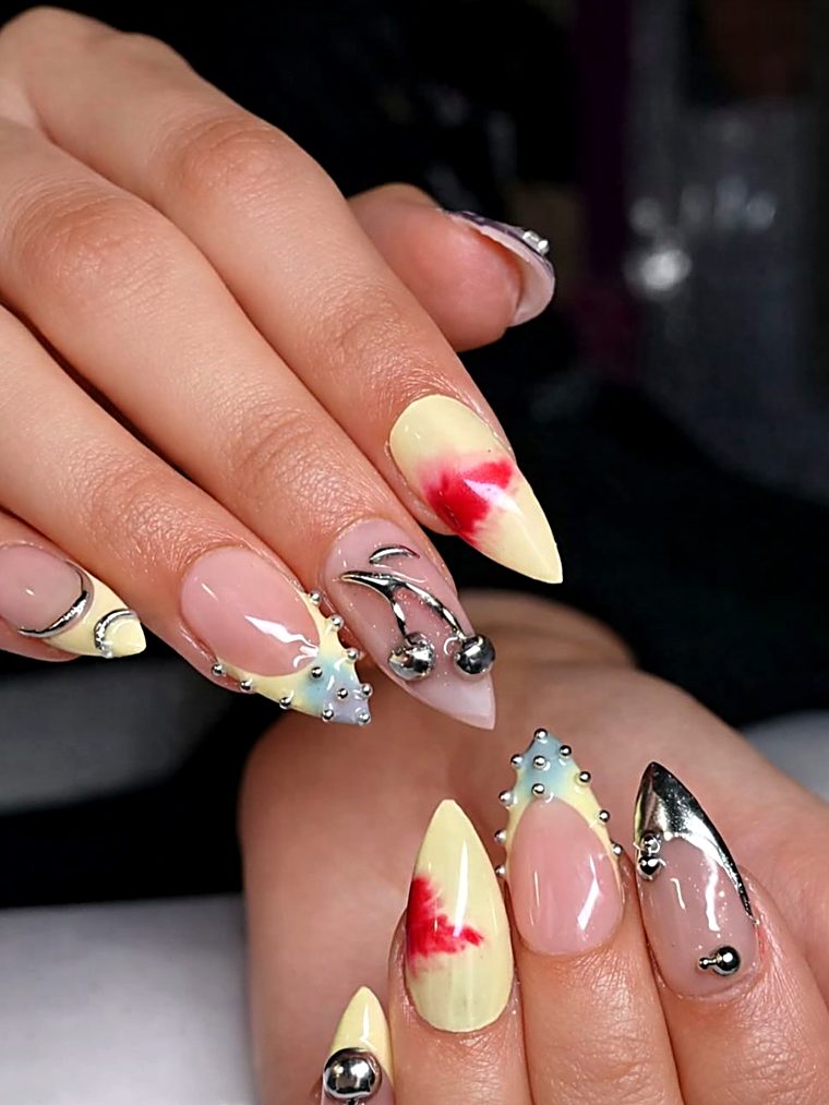 Butter yellow nails with red blooms, chrome tips and silver beads
